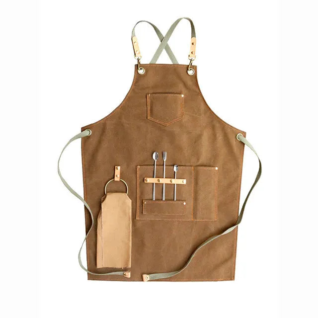 Canvas cross-back apron in camel colour on a mannequin, showing adjustable neck and waist ties