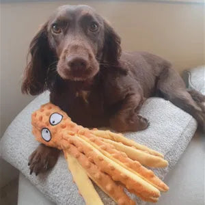 Blue octopus plush dog squeaky toy with no stuffing on a white background.