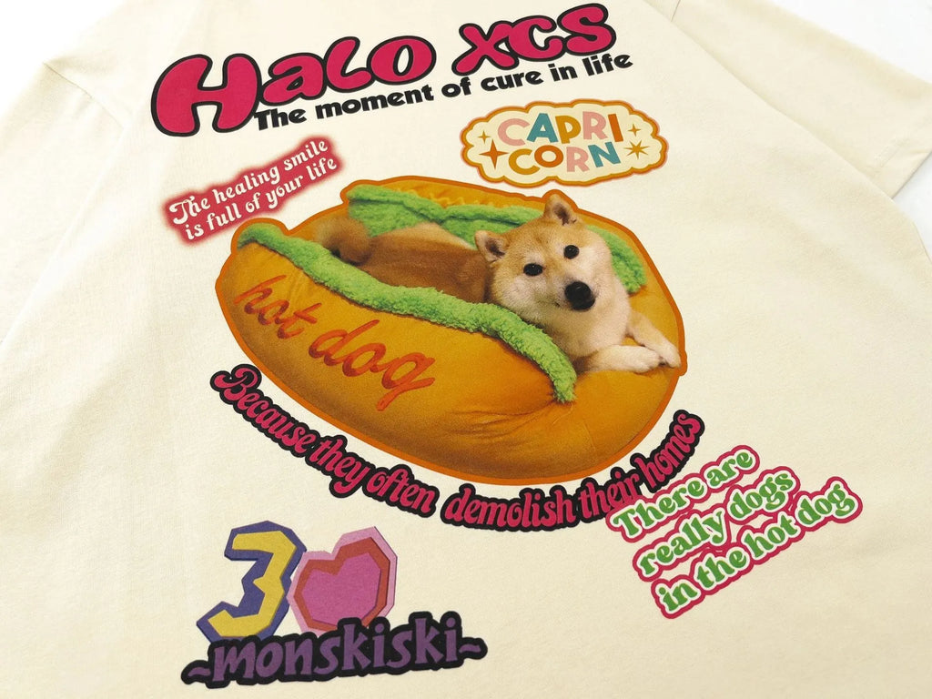 A white loose-fit cotton T-shirt with a large cartoon print of a hamburger dog.