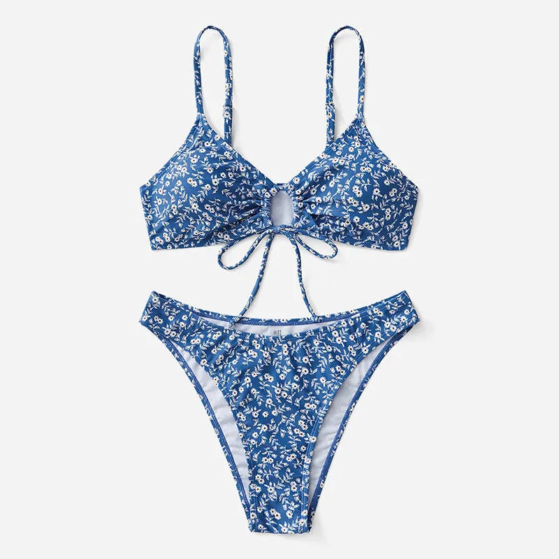 Blue women's three-piece swimsuit set with separate top and shorts on a white background.