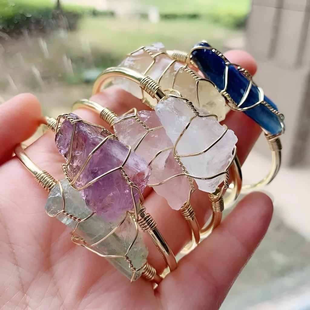 Unisex rough natural crystal bracelet with geometric gold metal winding on a wrist