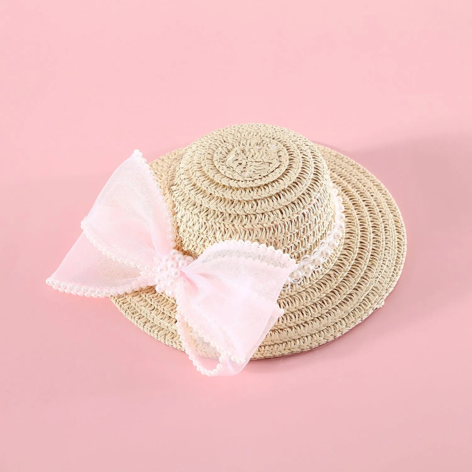 Cat wearing a woven Lafite leaves straw hat with a blue pearl butterfly bow.