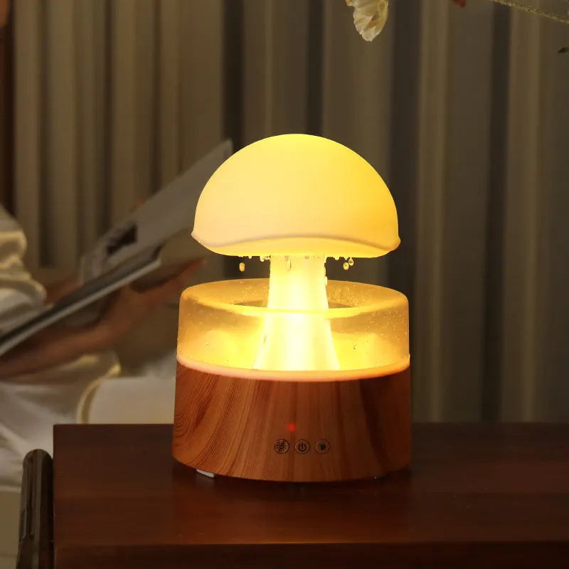White Rain Cloud Humidifier showing raindrop effect, colour-changing light, and remote control on a table.