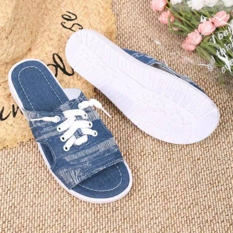 Blue Roman style canvas slippers with cloth upper and rubber sole displayed in adult sizes