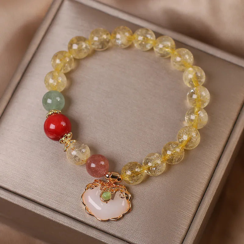 Women's alloy bracelet with a yellow citrine jade ruyi pendant on a white background.