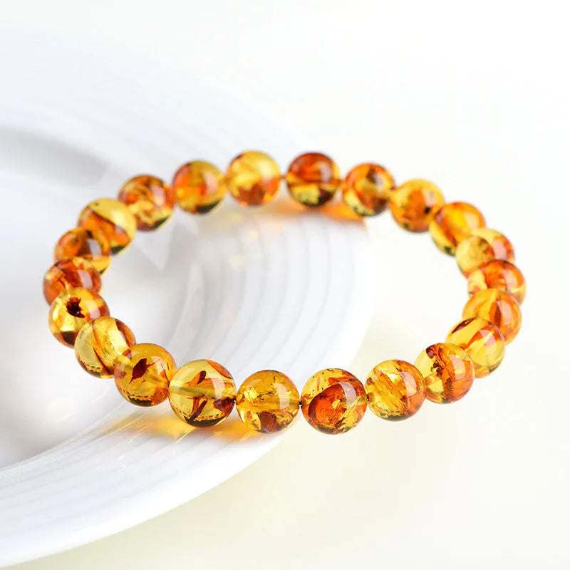 Natural yellow piebald amber bracelet with polished geometric beads on a string