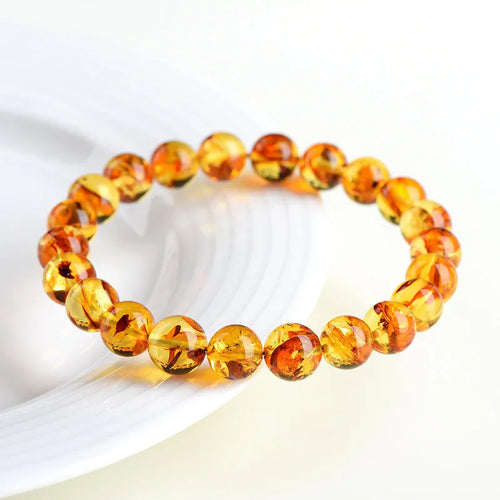 Natural yellow piebald amber bracelet with polished geometric beads on a string