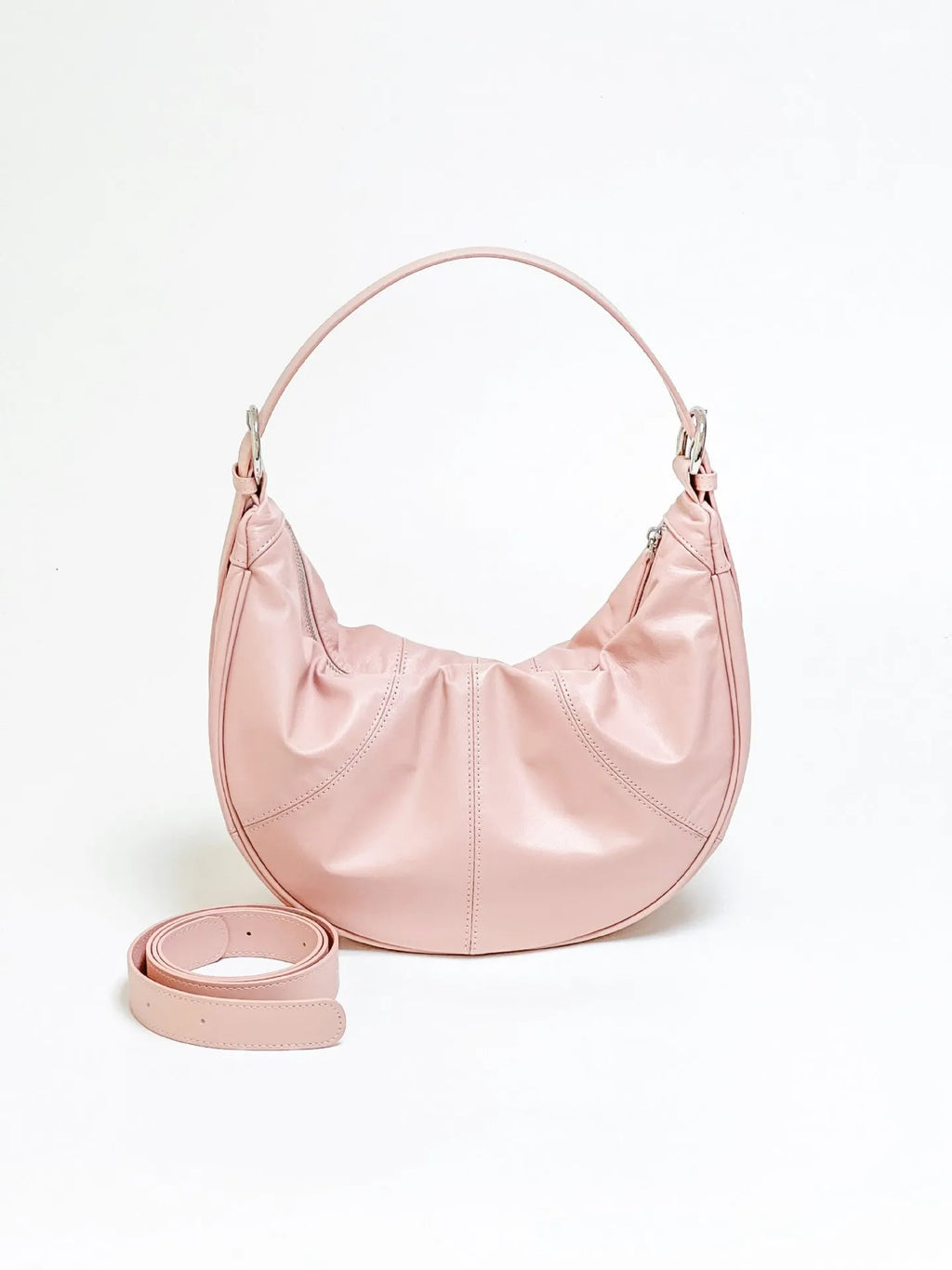 Women's soft cowhide leather shoulder bag in dumpling shape showing double straps and sandwich pocket.