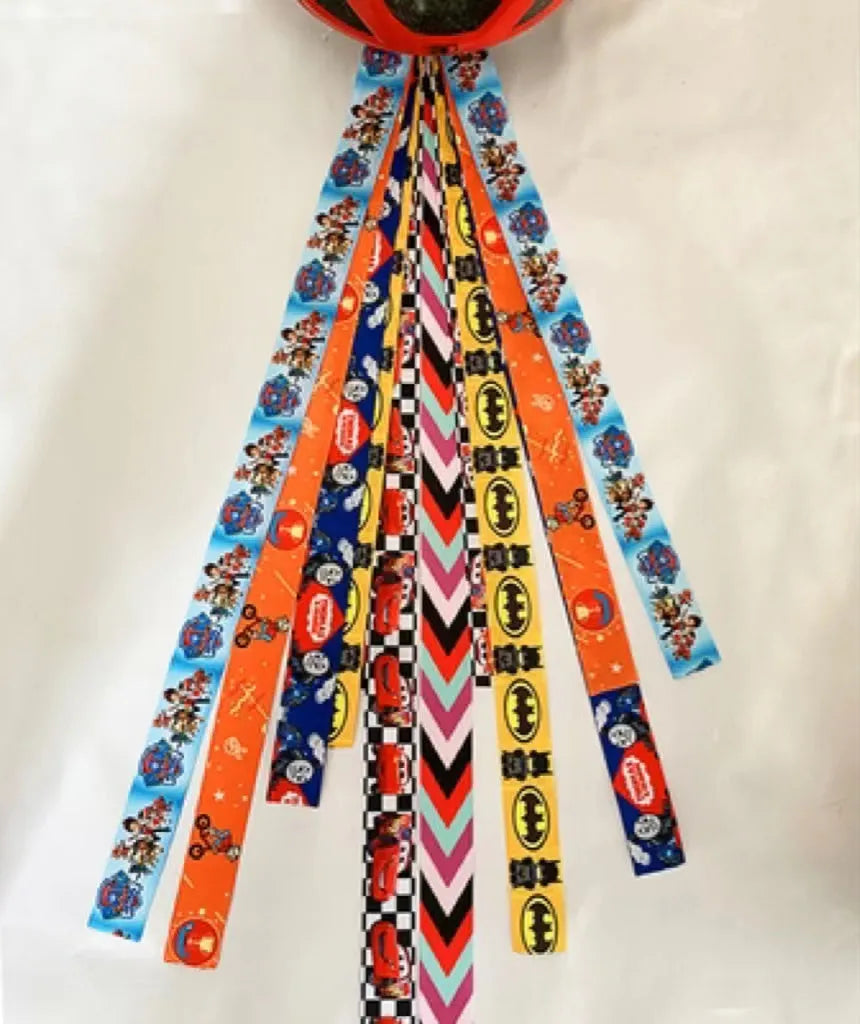 Decorative ribbon streamer for a child's ski or skating helmet in various colour options.