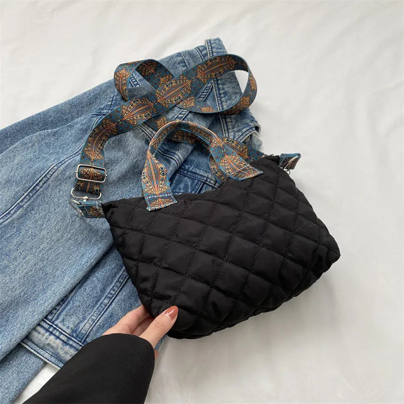 Simple shoulder messenger bag in Oxford cloth shown in multiple colours with embroidery detail and outer sandwich pocket.
