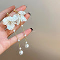 Women's acrylic shell pearl tassel earrings showing 8.8cm length with multiple clip style options