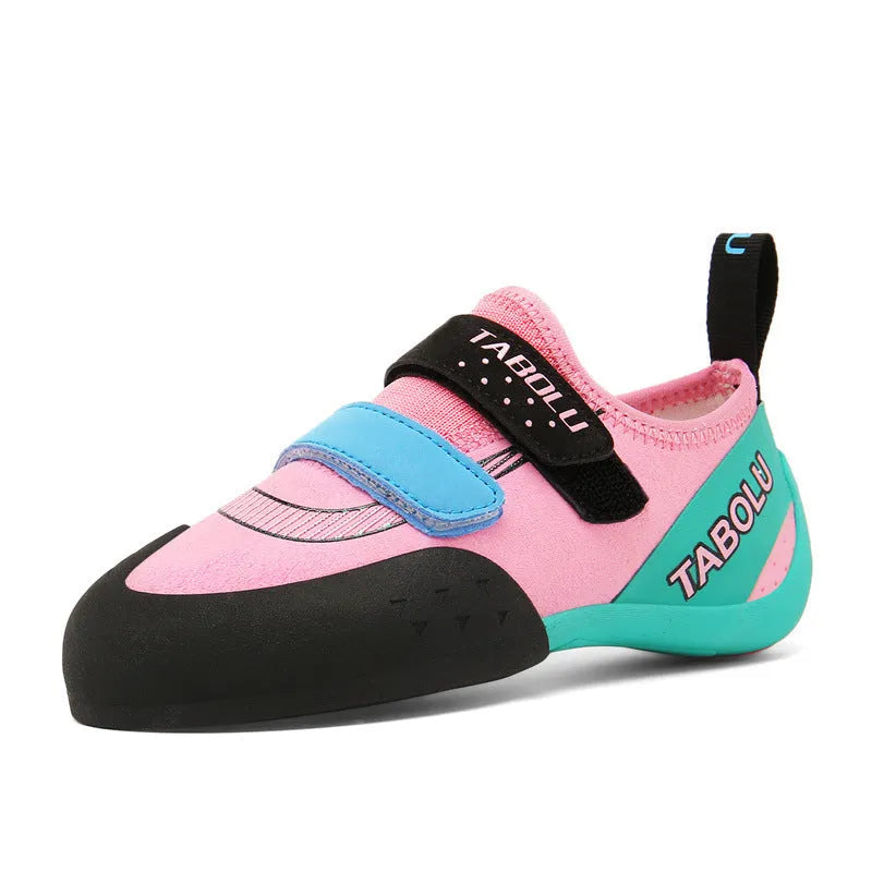 Black beginner rock climbing shoes with Velcro straps and a coloured accent on a rubber sole.