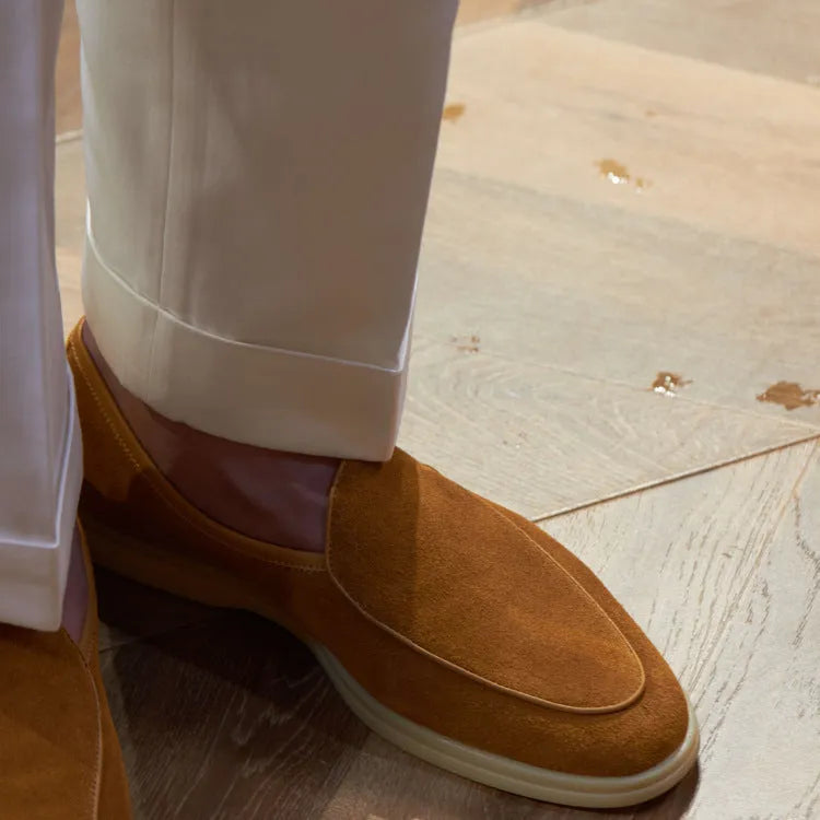 Men's brown handmade leather loafers with a flat TPR sole on a white background.