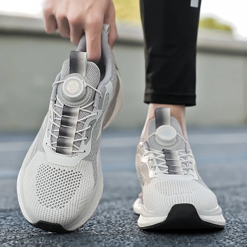 Men's low-top sports shoes with a rotating buckle closure and mesh uppers in a solid colour.
