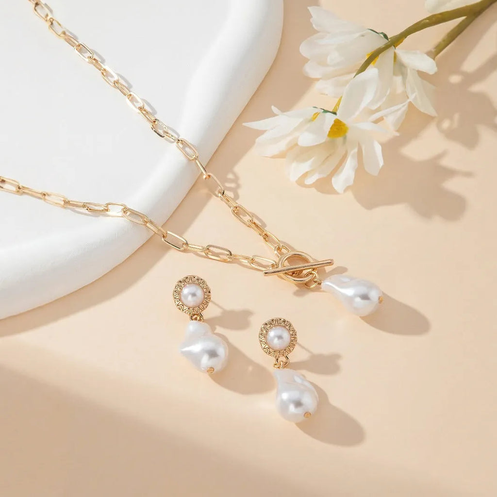Gold tone retro baroque pearl pendant necklace and matching stud earrings set for women.