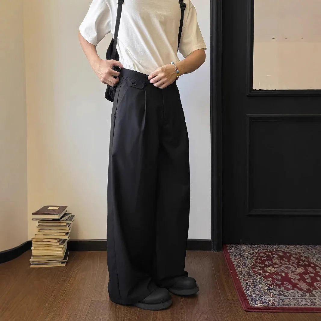 Brown men's straight-leg loose-fit suit trousers laid flat, showing wide-leg drape style.