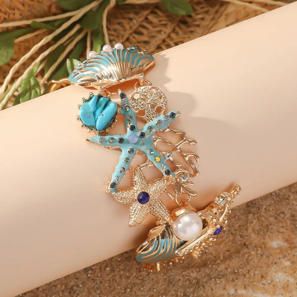 Women's alloy rhinestone marine shell and anchor bracelet with starfish charm in turquoise colour.