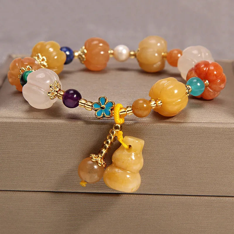 Women's yellow agate crystal beaded bracelet with gold silk thread and tassel.