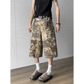 Yellow women's jeans with snake camouflage print, cropped length, and high waist.