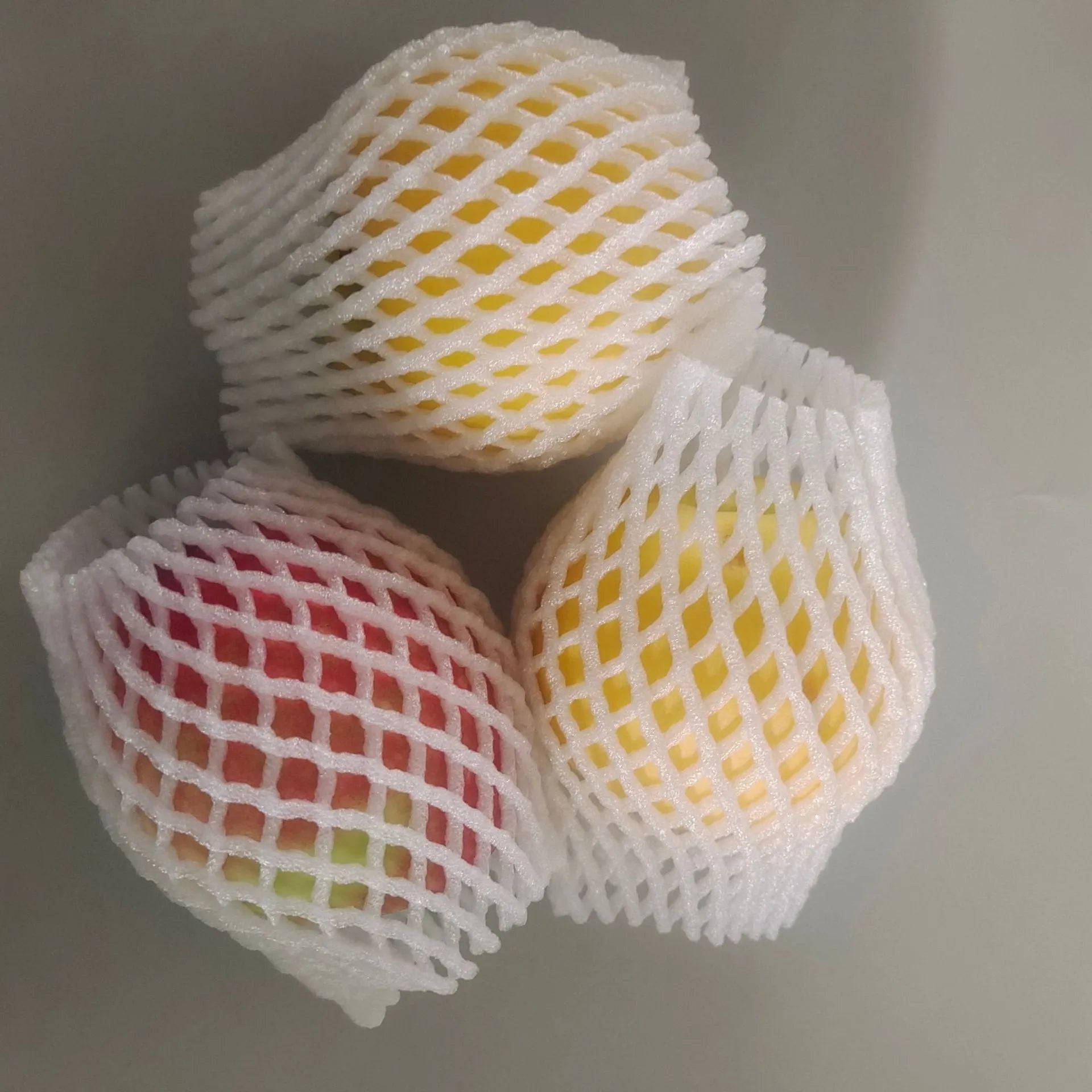 White foam fruit protection nets showing different sizes for apples, pears and peaches