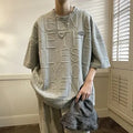 Grey men's loose fit t-shirt with a retro-style three-dimensional raised letter print on the front.