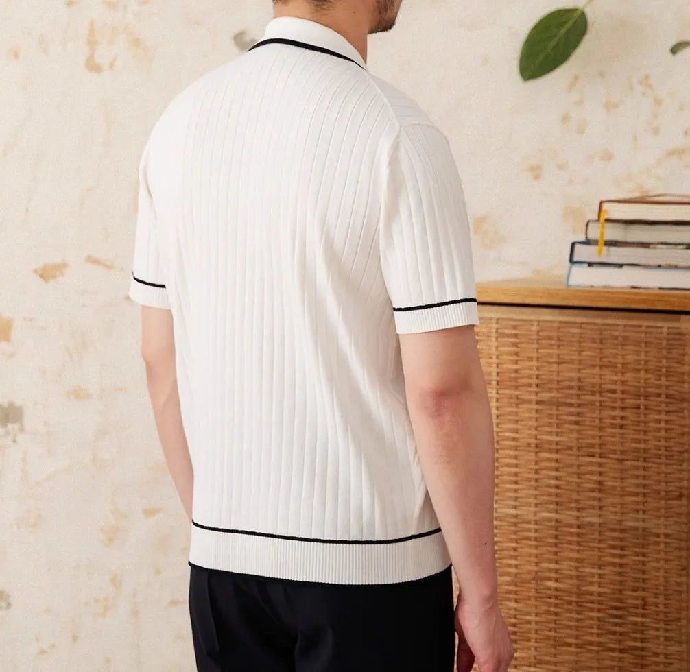 Man's black slim fit polo shirt with a lapel collar and short sleeves.