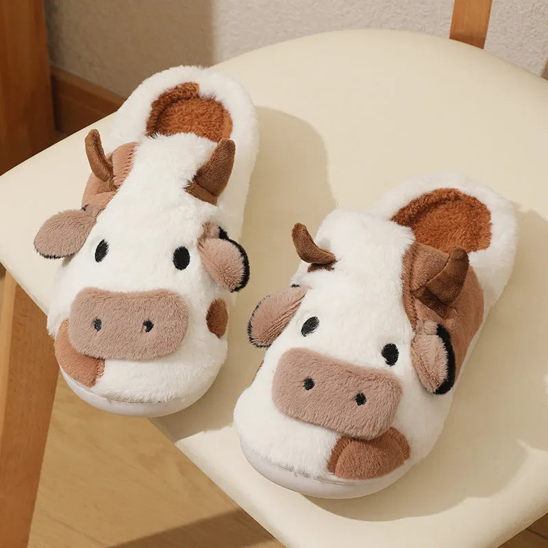 White cow-themed women's plush slippers with faux fur upper and textured non-slip sole