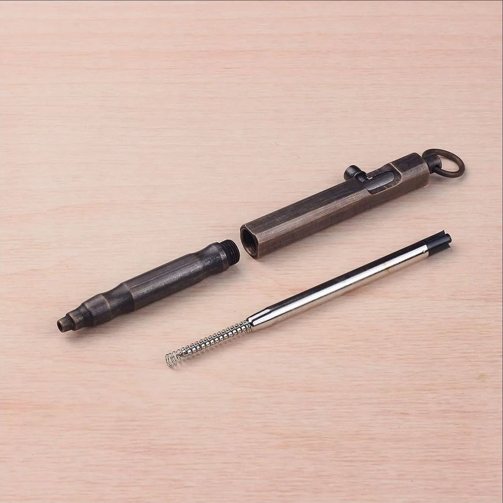 Brass tactical pen with hexagonal bolt design showing natural colour finish and precise machining details