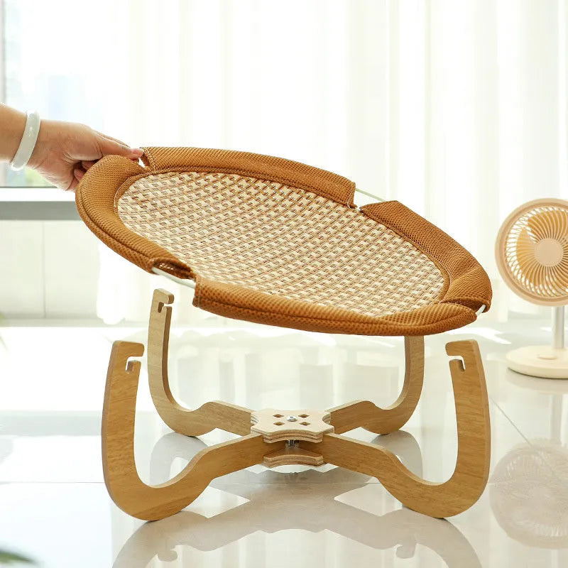 Brown woven rattan square pet hammock bed for cats and dogs, elevated off the ground.