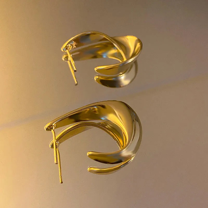 Pair of twisted geometric design metal earrings in gold or silver electroplated finish