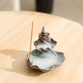 Purple clay ceramic reverse flow incense burner with lotus and plum blossom motifs