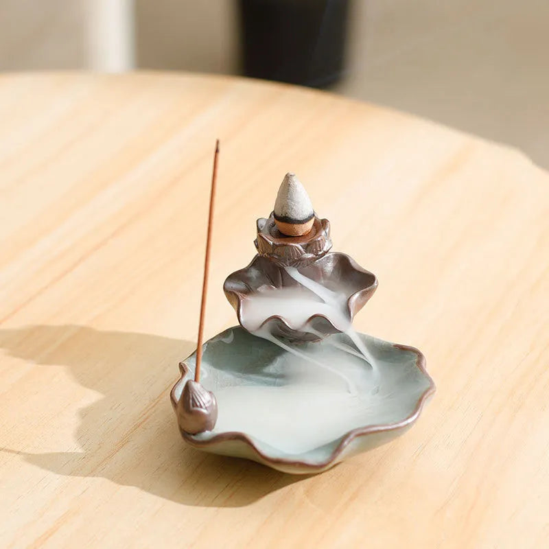 Purple clay ceramic reverse flow incense burner with lotus and plum blossom motifs