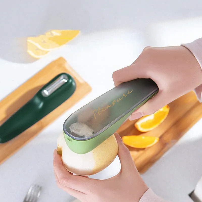 Dark green potato peeler with storage tube, stainless steel blade and plastic handle for kitchen use