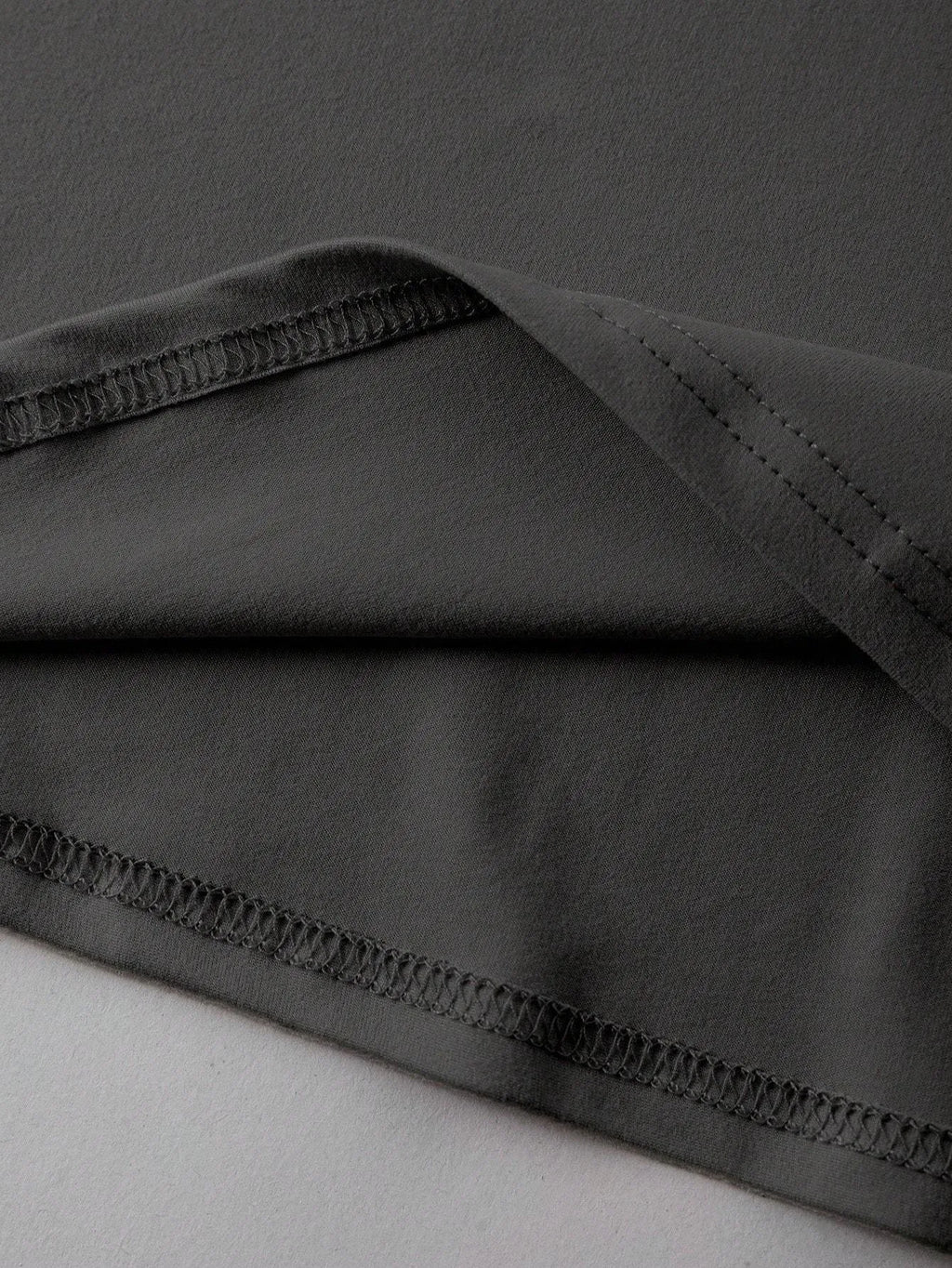 Loose-fit cotton summer T-shirt on a hanger, showing short sleeves and round neck in grey