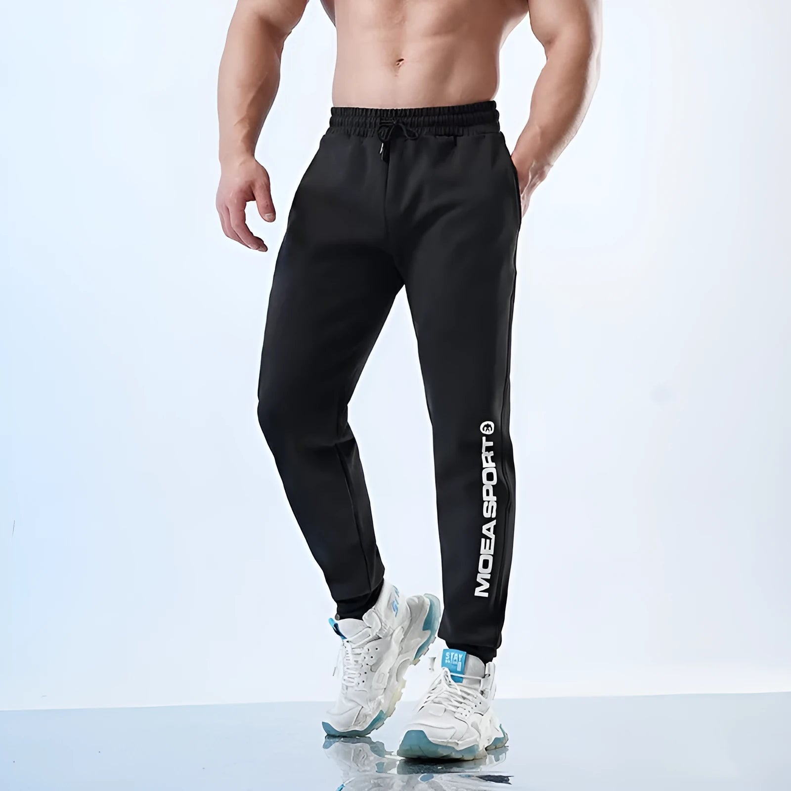 Men's grey sweatpants with adjustable ankle ties and mid waist, shown in folded and flat lay views