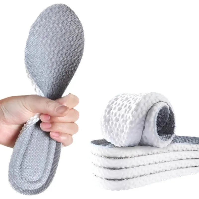 A pair of breathable grey PU foam sports insoles on a white background, shown with scissors to indicate their cut-to-fit feature.