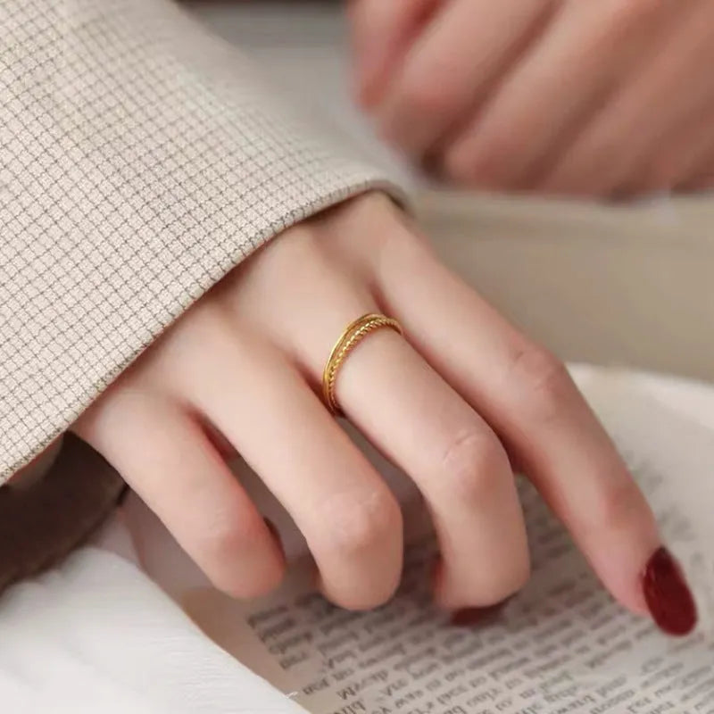 Brass gold plated women's ring showing simple bracelet and twist style options on a finger