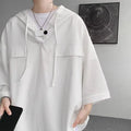Man wearing a loose fit black hooded short sleeve t-shirt for summer.