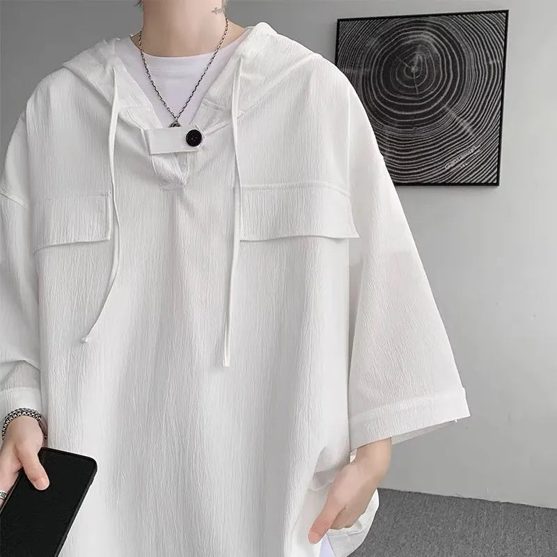 Man wearing a loose fit black hooded short sleeve t-shirt for summer.