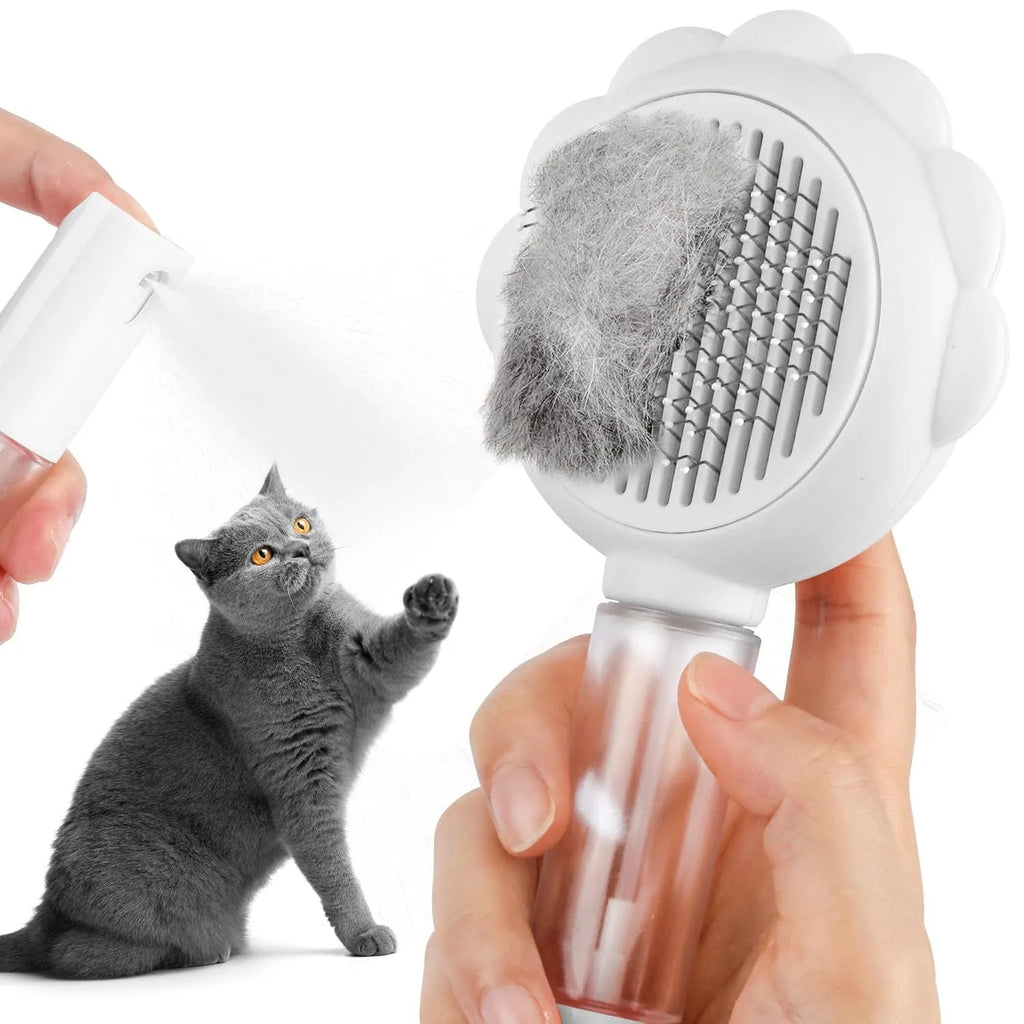 Grey spray cat brush with a release button on the handle, shown with stainless steel bristles.