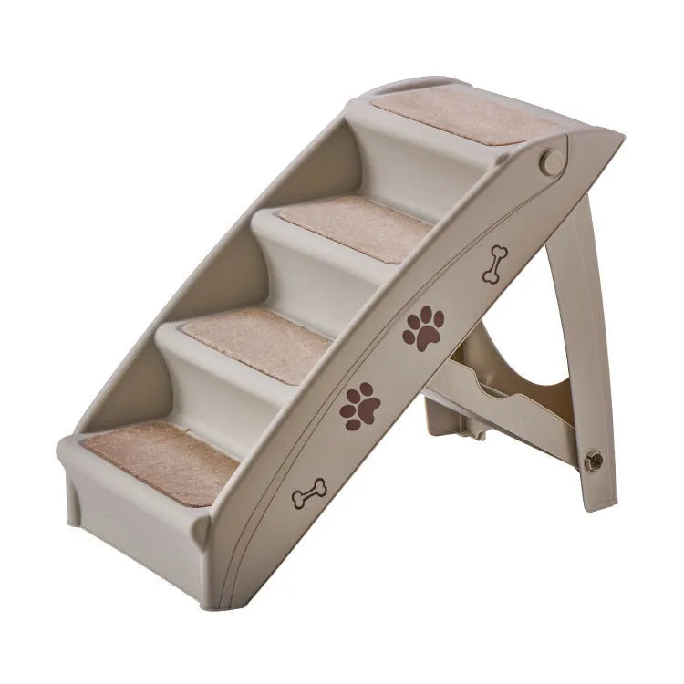 Foldable grey pet stairs with non-slip mats placed next to a sofa for dog or cat use