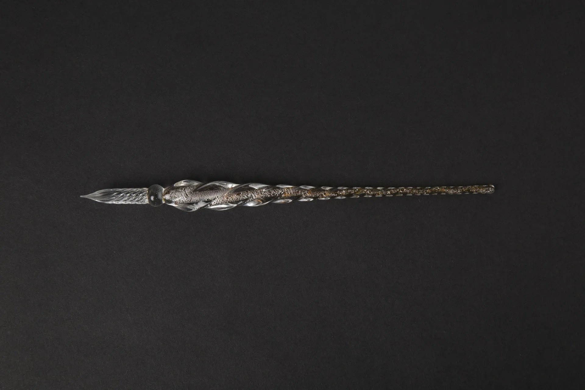Transparent glass crystal pen with coloured ink visible inside, abstract modelling design