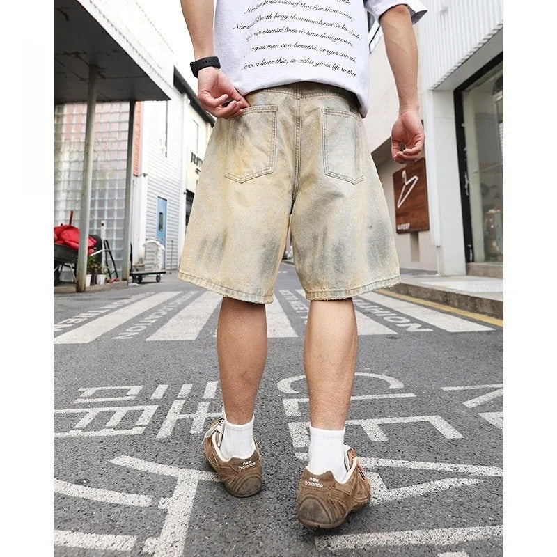 Light blue washed men's denim shorts with ripped details on a straight-leg cut