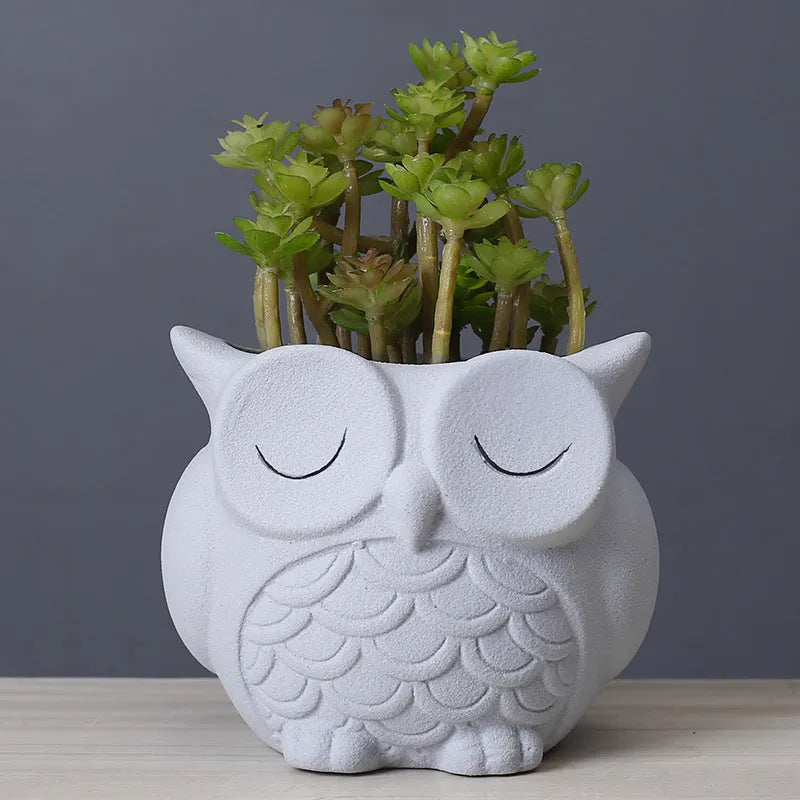 Handmade ceramic owl-design succulent pot in frosted light pink, white, green, or blue, measuring 11cm by 9cm.