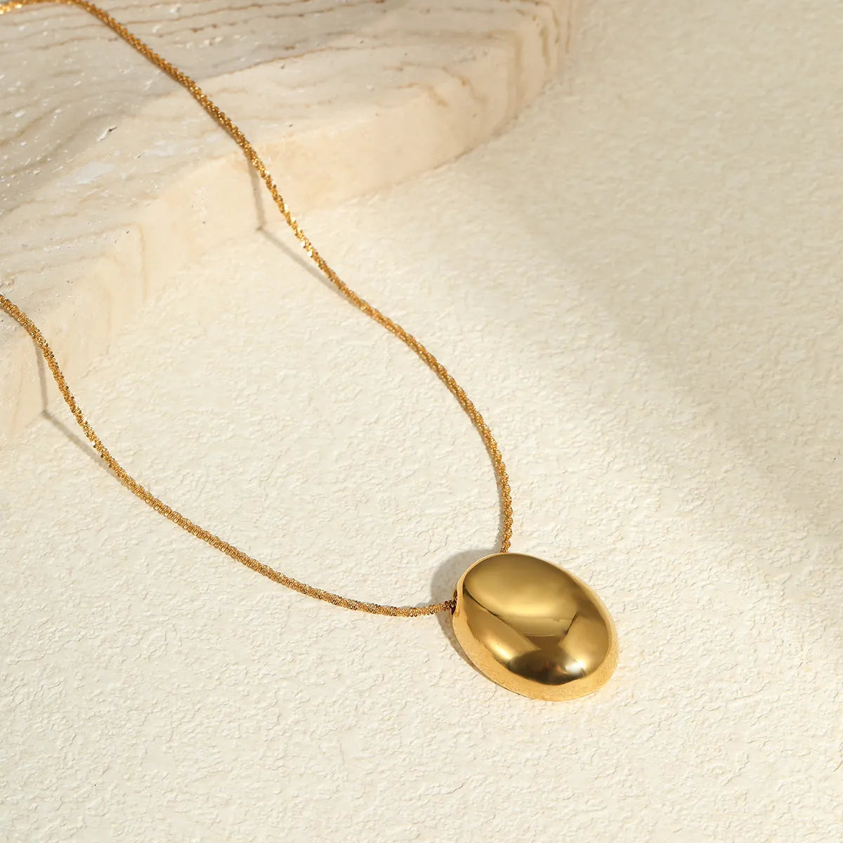 Gold geometric pendant necklace with 41-50cm chain on stainless steel background
