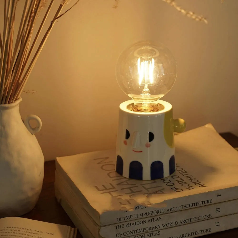 Handmade ceramic bedside lamp with spherical shade on wooden table