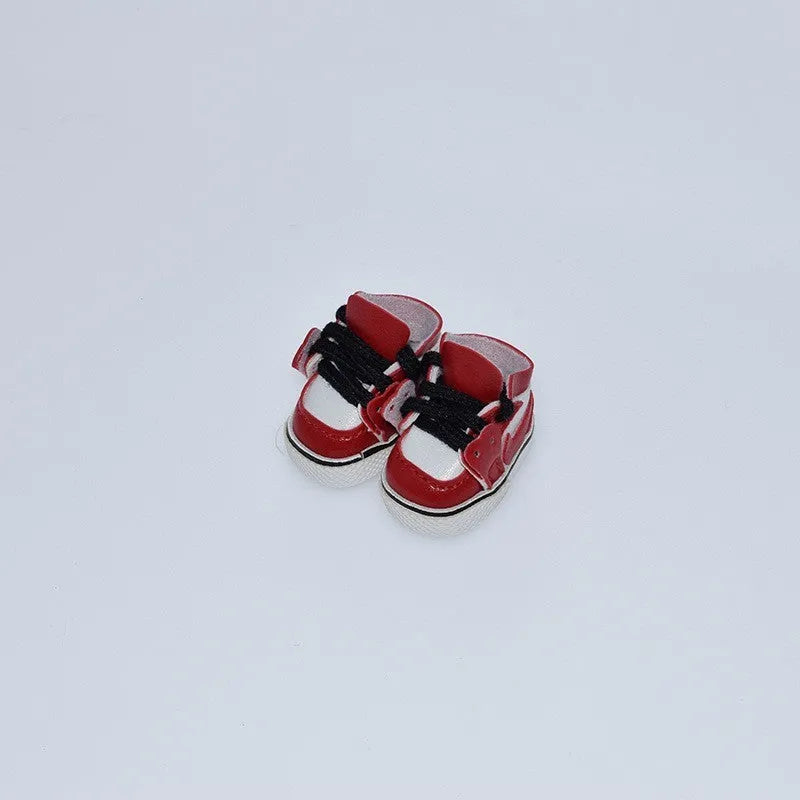 A pair of 17cm high PU replacement shoes for dolls in a selected style and colour.