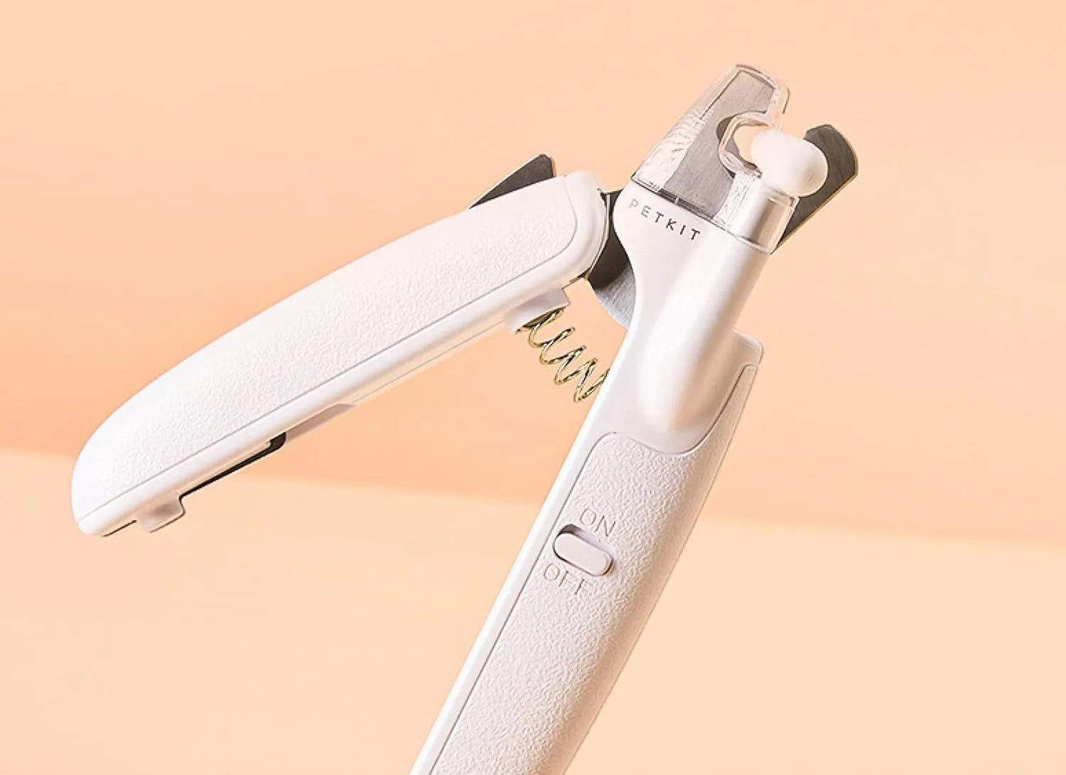 White LED pet nail clipper with a transparent anti-splash guard and a nail file on a white background.