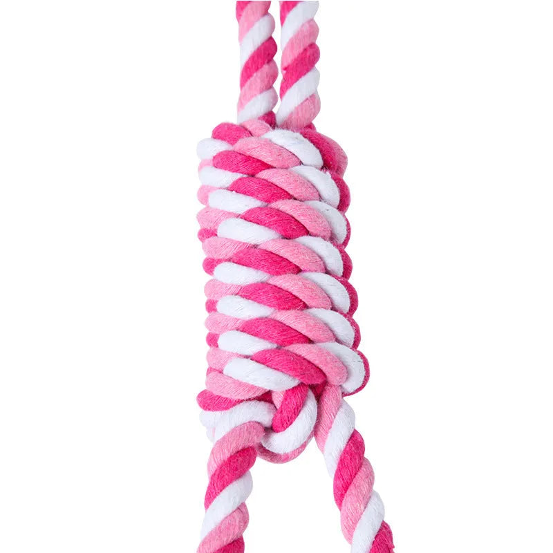 A long, braided red and white cotton rope dog toy for medium and large breeds.