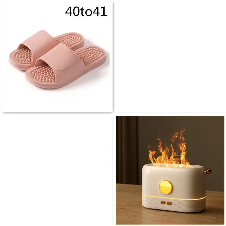 Black USB-powered humidifier with simulated orange flame effect and mist on a wooden desk.